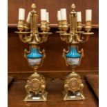 A pair of French 18th Century style gilt metal and porcelain four branch candelabra converted to