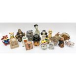 A collection of mixed treen and ceramic money boxes, all different characters