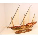 A wooden model ship, 'Indiscret', upon wooden stand. Measuring approx. 100cm length x 78cm height