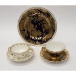 A Royal Crown Derby trio comprising cup, saucer and plate, cobalt blue ground decorated with gilt