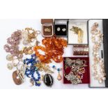 A collection of costume jewellery to include a silver and amber bracelet, bead necklaces including