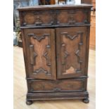 Queen Anne style oak cupboard with two single drawers above two cupboard doors above single