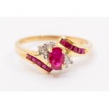 A ruby and 9ct gold dress ring, comprising a central claw set oval cut ruby approx 4 x 6mm,