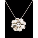 Tiangius Jackson- a silver pendant in the form or a flower with applied circular disc decoration and