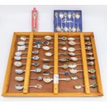 A collection of commemorative of plated teaspoons in wooden display case and other (Q)