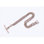 A 9ct rose gold double link Albert chain with two swivel clasps suspending a T bar, each link marked