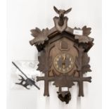 Cuckoo wall clock, two bellows, Black Forest-style case carved with deer, pediment leaf pendulum.