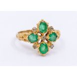 An emerald 9ct gold cluster ring, comprising a quatrefoil of oval cut emeralds, set with diamond