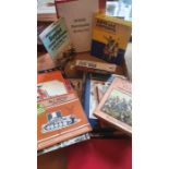 A mixed box of uniform guides and books