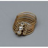 Articulated multi ring fiddle ring, unmarked but tests as high grade gold, set with seed pearls