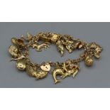 9ct gold charm bracelet plus a number of yellow metal charms to include 3 hallmarked 9ct gold charms