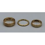 A trio of wedding bands. A gents and ladies (size X and G), gross weight 8.1 gm plus an 18ct gold