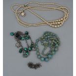 A selection of items of vintage costume jewellery to include a vintage marcasite brooch, a turquoise