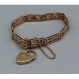 An ornate gate bracelet in Victorian 9ct rose gold with a 9ct yellow gold heart, gross weight approx