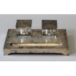 A 1930's Art Deco inspired inkwell and pen stand in sterling silver with glass inserts with sterling