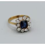 A royal blue sapphire dress ring in 18ct yellow gold, blue stone measuring 8 x 6mm with ten x 0.10ct