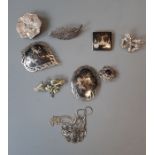 A selection of eight silver and white metal brooches, two 925 stamped chains, one a double strand to