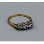 A three stone diamond and 18ct gold ring, size P 1/2, gross weight 3.5gm. Estimated total carat