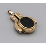 A watch key pendant set with carnelian and bloodstone in a spinning mount with engraved pattern,