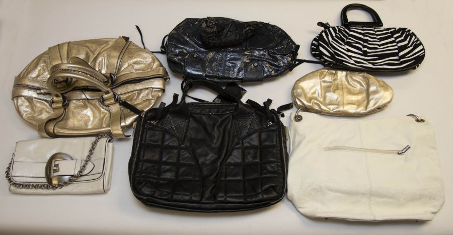 A collection of 13 handbags: one pearl white leather Coccinelle bag; one Abbacino black-and-white