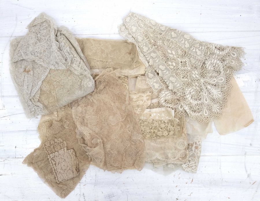 A collection of 19th Century lace work including a large collar, shawl, doillies, trimmings and