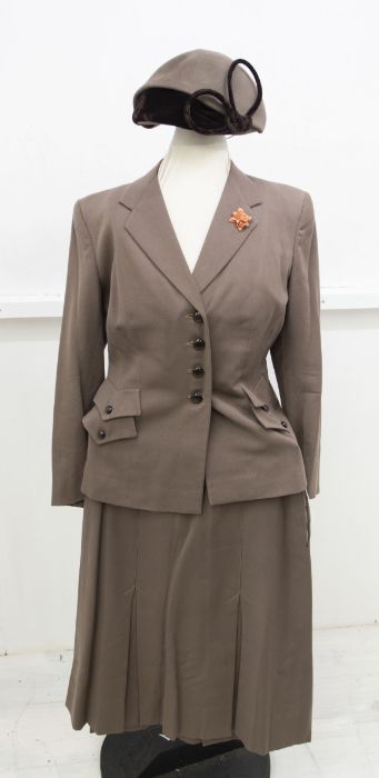A mid to late 1940's fawn Gaberdine suit, fitted jacket with two flap pockets on each side of