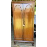 An early 20th cent mahogany wardrobe of slender proportions, raised on cabriole support