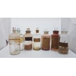 7 similar antique blown glass chemist bottles, with glass stoppers. Includes tincture of rhubarb