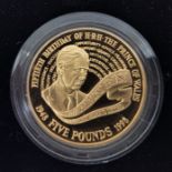 An Elizabeth II gold proof Five Pounds (Crown) commemorative coin Prince Charles' 50th Birthday.