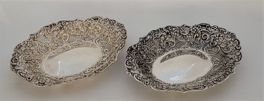 A pair of Victorian oval silver baskets, by William Comyns & Sons, London 1895, repousse and pierced