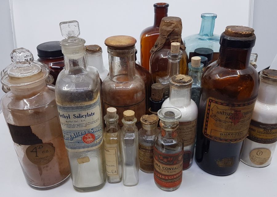 A collection of 30 pharmacy bottles, of assorted sizes, shapes and labels. Mid 20th century and