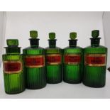 Matching set of 4 antique ribbed green glass chemist poison bottles; with original stoppers and