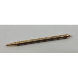 A 9ct. gold propelling pencil, with engine turned decoration, length 9.5cm. (gross weight 9.3g)