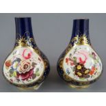 A pair of early nineteenth century Derby porcelain vases, c. 1820. Each has central vignette with