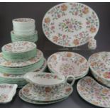 An extensive Minton Haddon Hall pattern dinner service, comprising of: eight dinner plates, eight