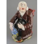 An early nineteenth century pearlware night watchman toby jug, c. 1820. It is decorated with a brown