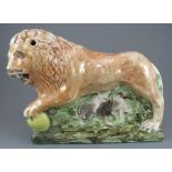 An early nineteenth century large pearlware lion, c. 1820. It is decorated with a lustre glaze. 34