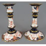 A pair early twentieth century Royal Crown Derby porcelain Imari candlesticks, c. 19020. Both are