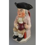 An early nineteenth century pearlware toby jug, c. 1800-20. It is decorated with a pink jacket and