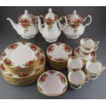 An extensive Royal Albert Country Roses tea service, comprising of: eight cups and saucers, fourteen