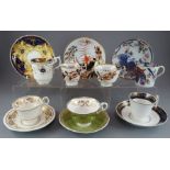 A group of early nineteenth century hand-painted mainly Spode porcelain cups and saucers and one