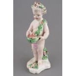 A late eighteenth century porcelain Derby cherub with applied floral decoration and hand-painting,