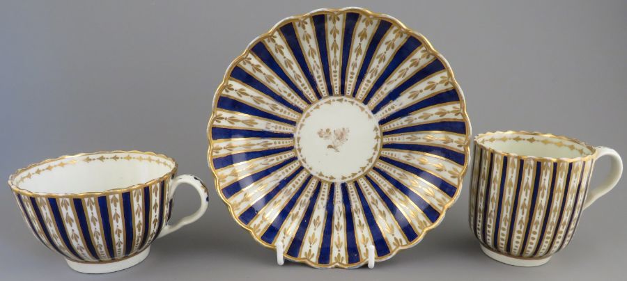 A late eighteenth century hand-painted and gilded Worcester porcelain trio, c. 1770-80. It is