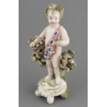 A late eighteenth century porcelain Derby cherub with applied floral decoration and hand-painting,