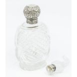 An Edwardian large cut glass scent bottle and stopper, with silver collar and cover chased and