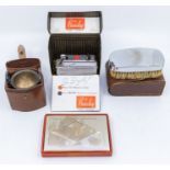 A set of six Walker & Hall silver plated beakers, in leather case; a plated cigarette case Consort