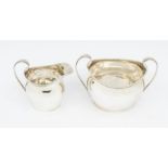 An Edwardian Scottish part silver tea service to include milk jug and sugar bowl, plain Georgian