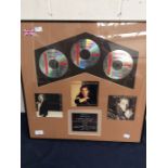 Framed CD's of Michael Bolton, as presented to him by Columbia Records for combined record sales of