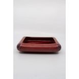William Moorcroft for Liberty, a Flamminian Ware bowl, red glazed rectangular form with moulded
