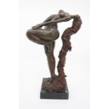 A bronze figure of a lady with flowing red hair on a marble plinth.